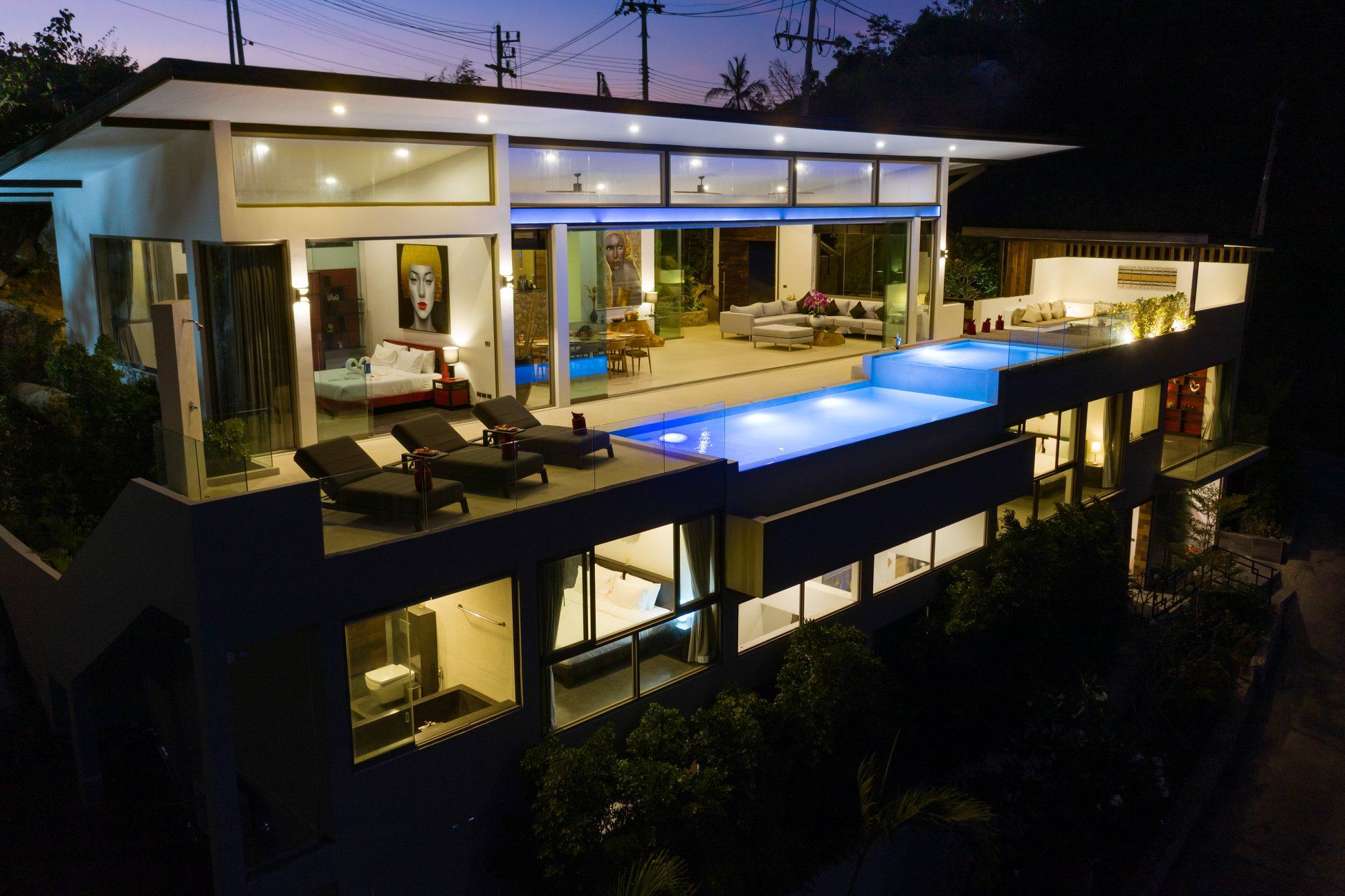 Villa 369 night facade with blue-lit infinity pool and 3-level architecture, Chaweng Noi