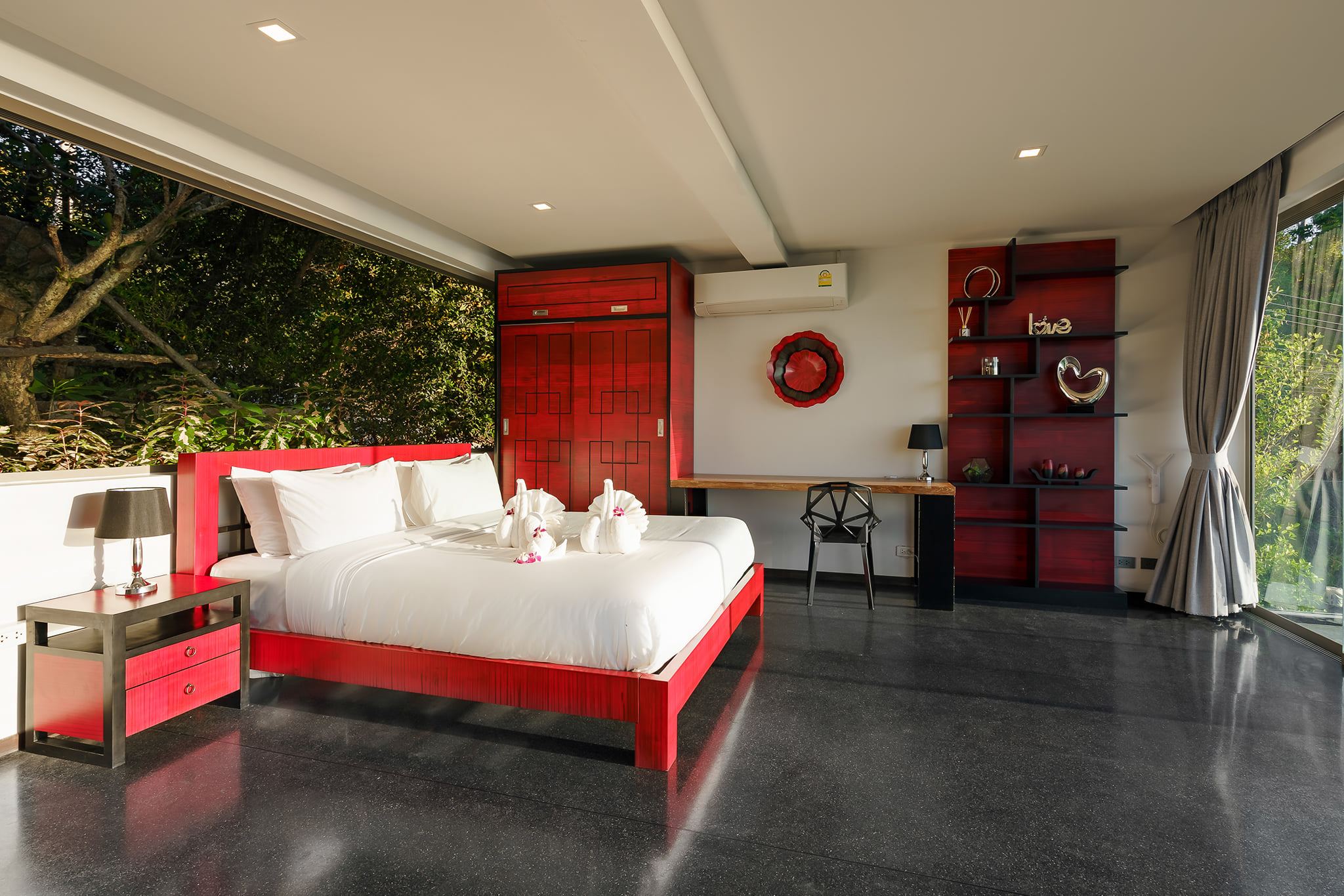 Villa 369 Suite Three — red accent king bed with garden view