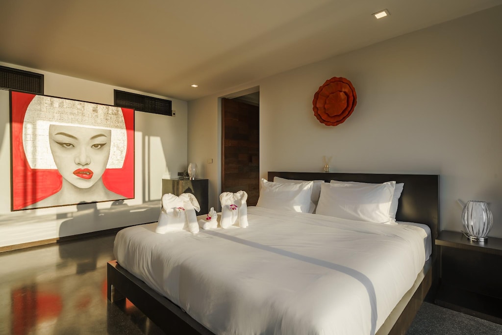 Villa 369 Suite Two — king bed with art portrait and ocean view